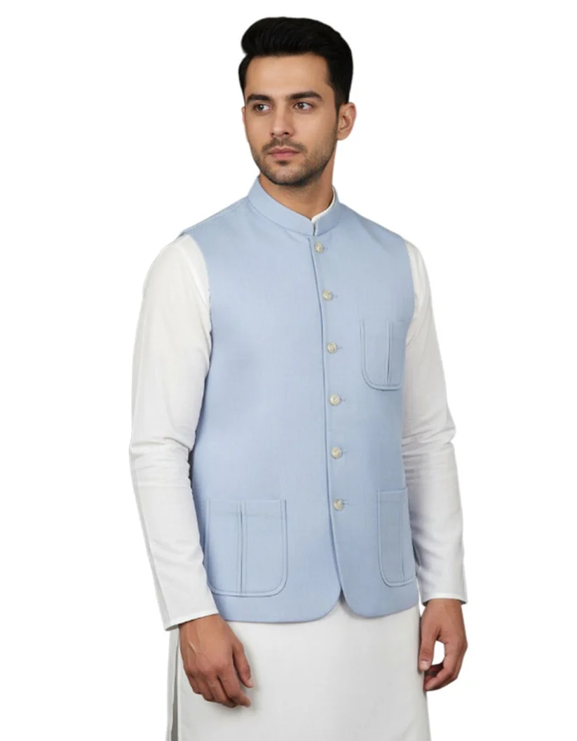 Sky-blue waistcoat over a white kameez